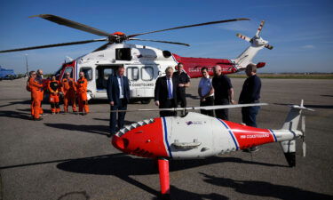 UK Prime Minister Boris Johnson looks at a Coastguard drone for the surveillance and rescue of migrants in southeast England on Thursday.