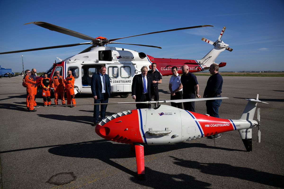 <i>Matt Dunham/Pool/AP</i><br/>UK Prime Minister Boris Johnson looks at a Coastguard drone for the surveillance and rescue of migrants in southeast England on Thursday.