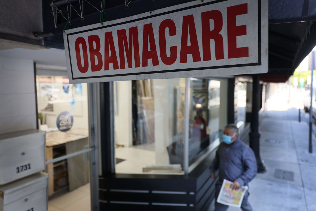 <i>Joe Raedle/Getty Images</i><br/>A pedestrian walks past the Leading Insurance Agency