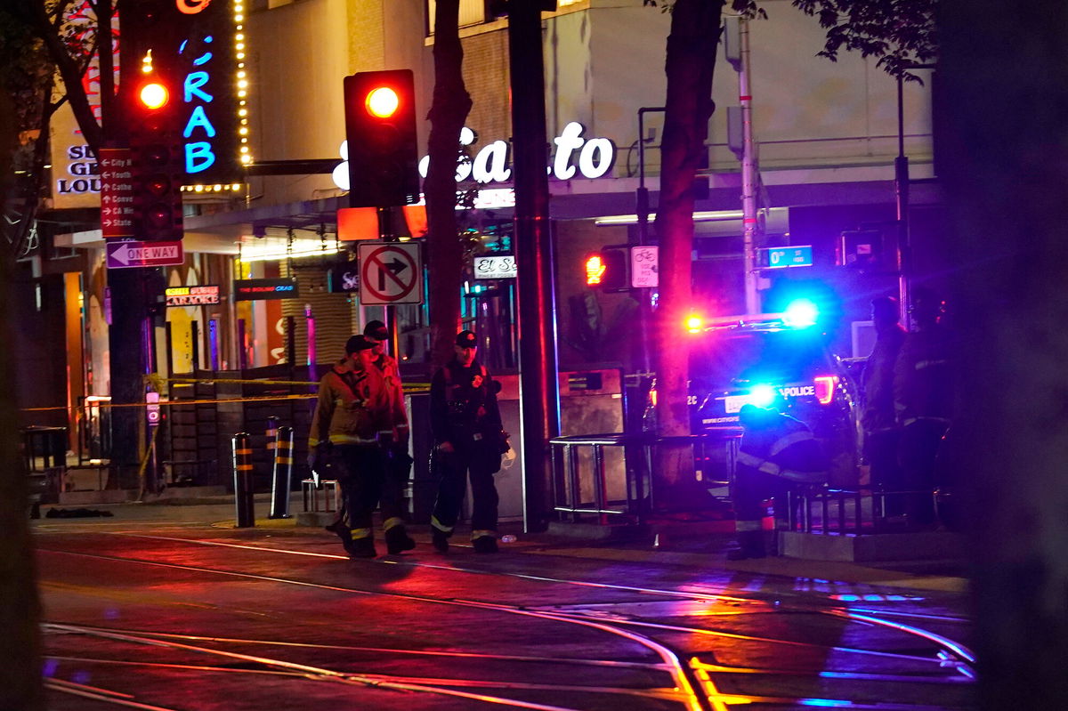 <i>Rich Pedroncelli/AP</i><br/>Emergency personnel walk near the scene of the shooting early Sunday morning.