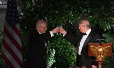 Former US President Donald Trump and Australian Prime Minister Scott Morrison toast during a state dinner at the Rose Garden of the White House in Washington