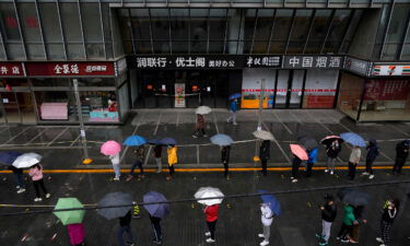 Locked-down residents line up in the rain for Covid tests in Beijing on April 27.