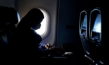 A passenger wears a face mask as she travels on a flight from Hartsfield-Jackson International Airport in Atlanta.