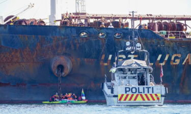 A police boat is pictured at the scene as members of Greenpeace stage a protest against the Ust Luga on April 25.