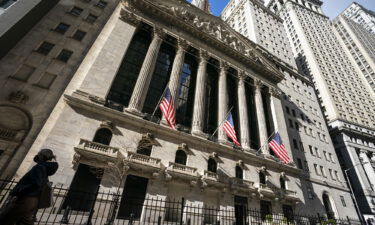 Analysts say stocks may soar just before they collapse. A pedestrian walks past the New York Stock Exchange