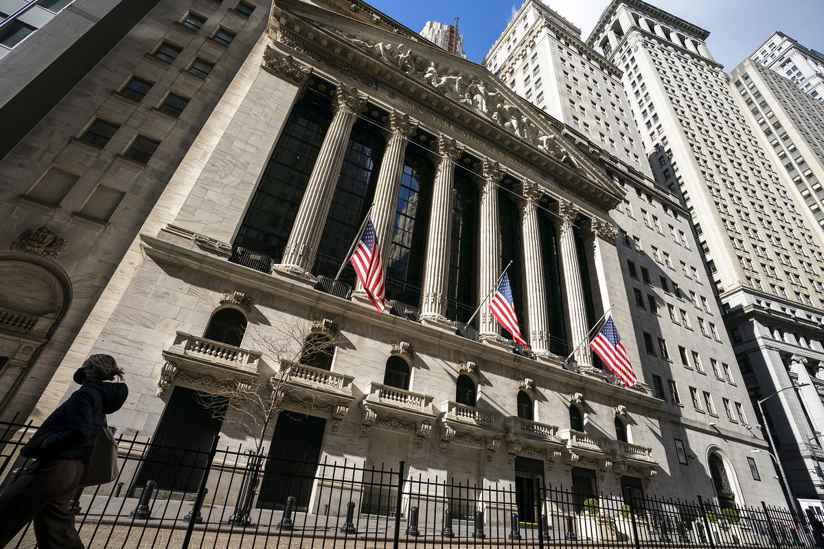 <i>John Minchillo/AP</i><br/>Analysts say stocks may soar just before they collapse. A pedestrian walks past the New York Stock Exchange