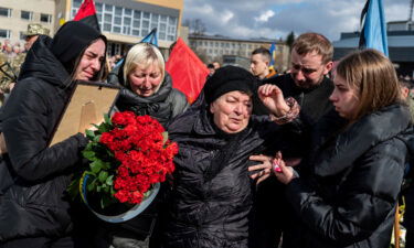 Mourners react during the funeral ceremony of Ukrainian serviceman Roman Tiaka