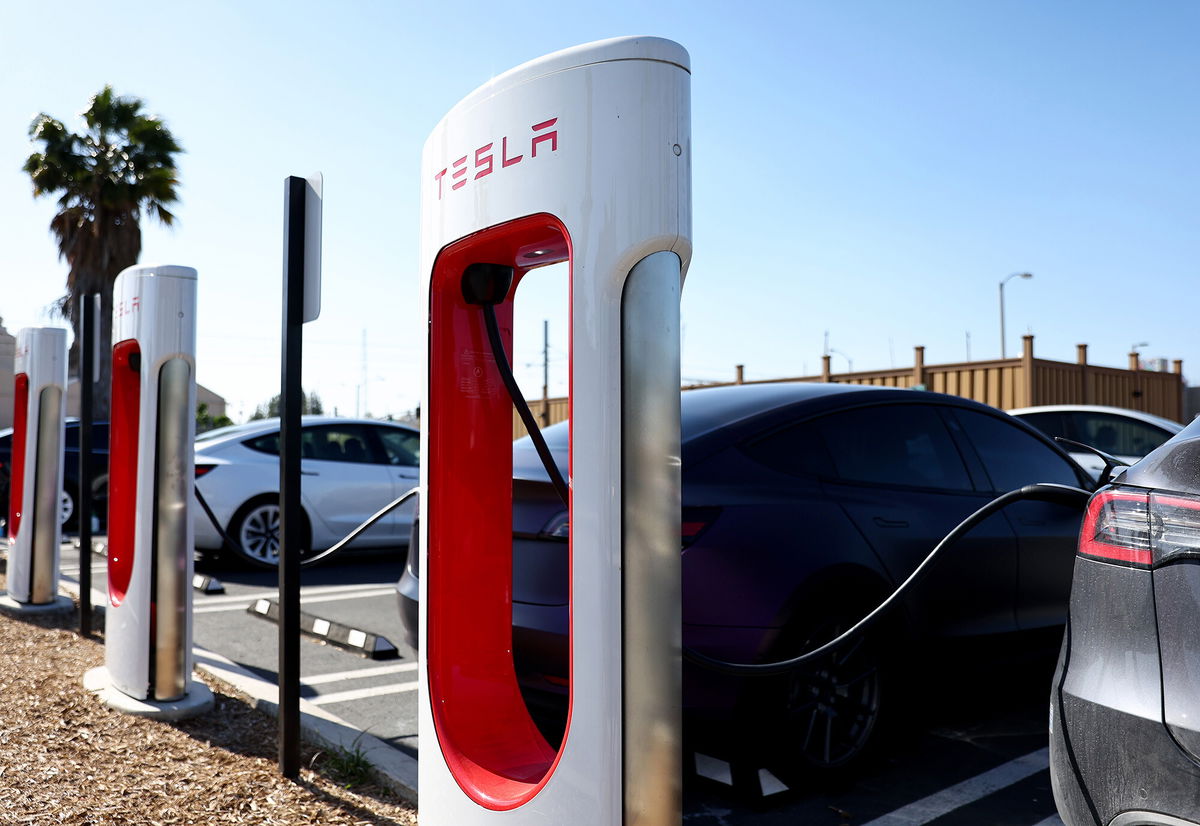 <i>Mario Tama/Getty Images</i><br/>Tesla cars recharge at a Tesla Supercharger station on April 14