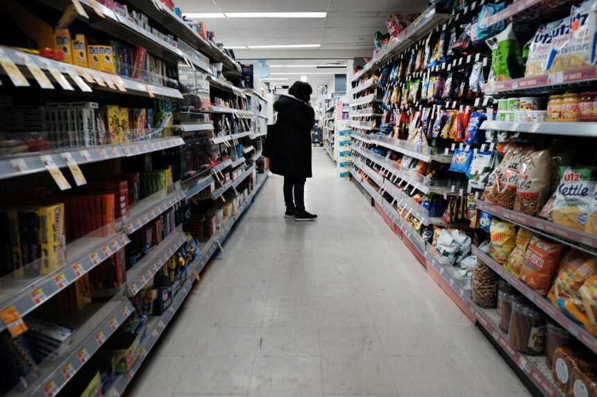 People shop in a store in Brooklyn on March 10 in New York City. The price of gas