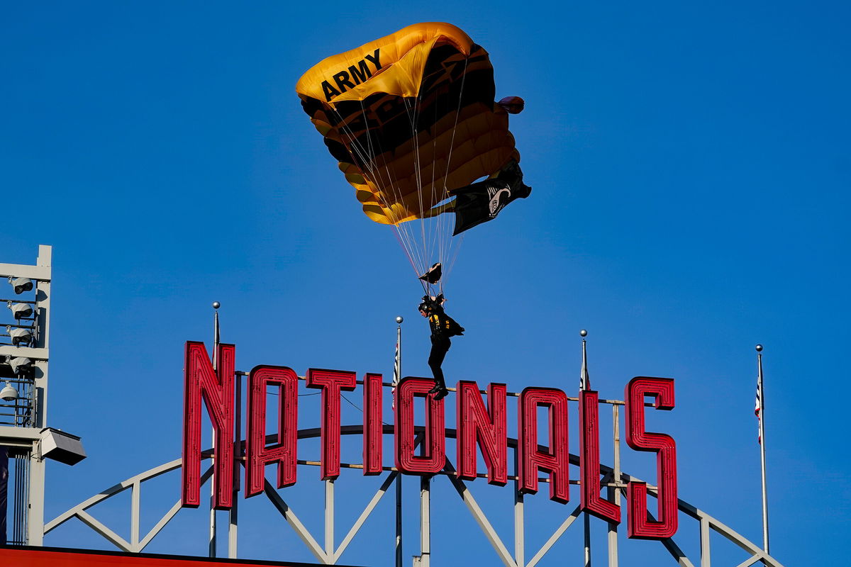 <i>Alex Brandon/AP</i><br/>A member of the Army Golden Knights descends into National Park before a baseball game between the Washington Nationals and the Arizona Diamondbacks on Wednesday