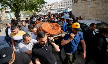 Mourners carry the body of Ghada Sabateen during her funeral in the West Bank village of Husan on April 10.