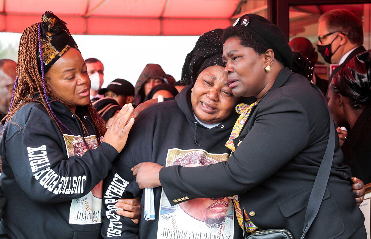 <i>Rebecca Cook/Reuters</i><br/>Dorcas Lyoya gets emotional following the funeral of her son