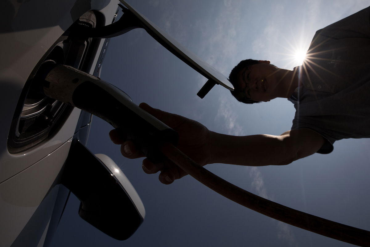 <i>SeongJoon Cho/Bloomberg/Getty Images</i><br/>Seen here is a man charging a hybrid Chevrolet in Jeju