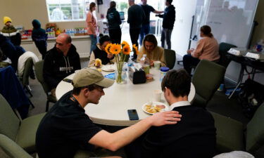 Volunteer Silas Breen prays at Calvary San Diego on April 1 with David