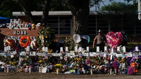 FILE - Flowers and candles are placed around crosses at a memorial outside Robb Elementary School to honor the victims killed in this week's school shooting in Uvalde, Texas, Saturday, May 28, 2022. (AP Photo/Jae C. Hong, File)