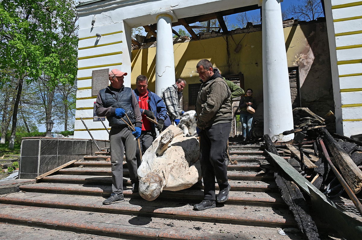 <i>Sergey Bobok/AFP/Getty Images</i><br/>Museum workers carry the sculpture of Ukrainian philosopher Hryhorri Skovoroda from the destroyed building of the Hryhoriy Skovoroda National Literary Memorial Museum  in the village of Skovorodynivka