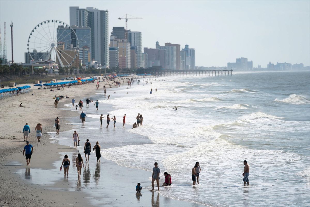 <i>Sean Rayford/Getty Images</i><br/>People walk along the beach the morning of May 29 in Myrtle Beach