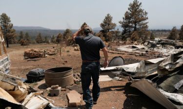 Michael Salazar walks through his property that was burned during the Hermits Peak and Calf Canyon fires in Tierra Monte