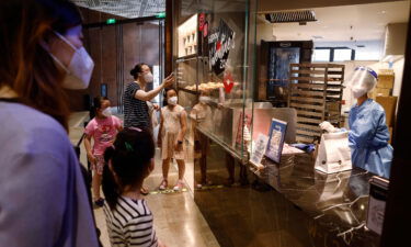 Customers shop for bread at "1000 Trees" shopping mall in Putuo district on May 26