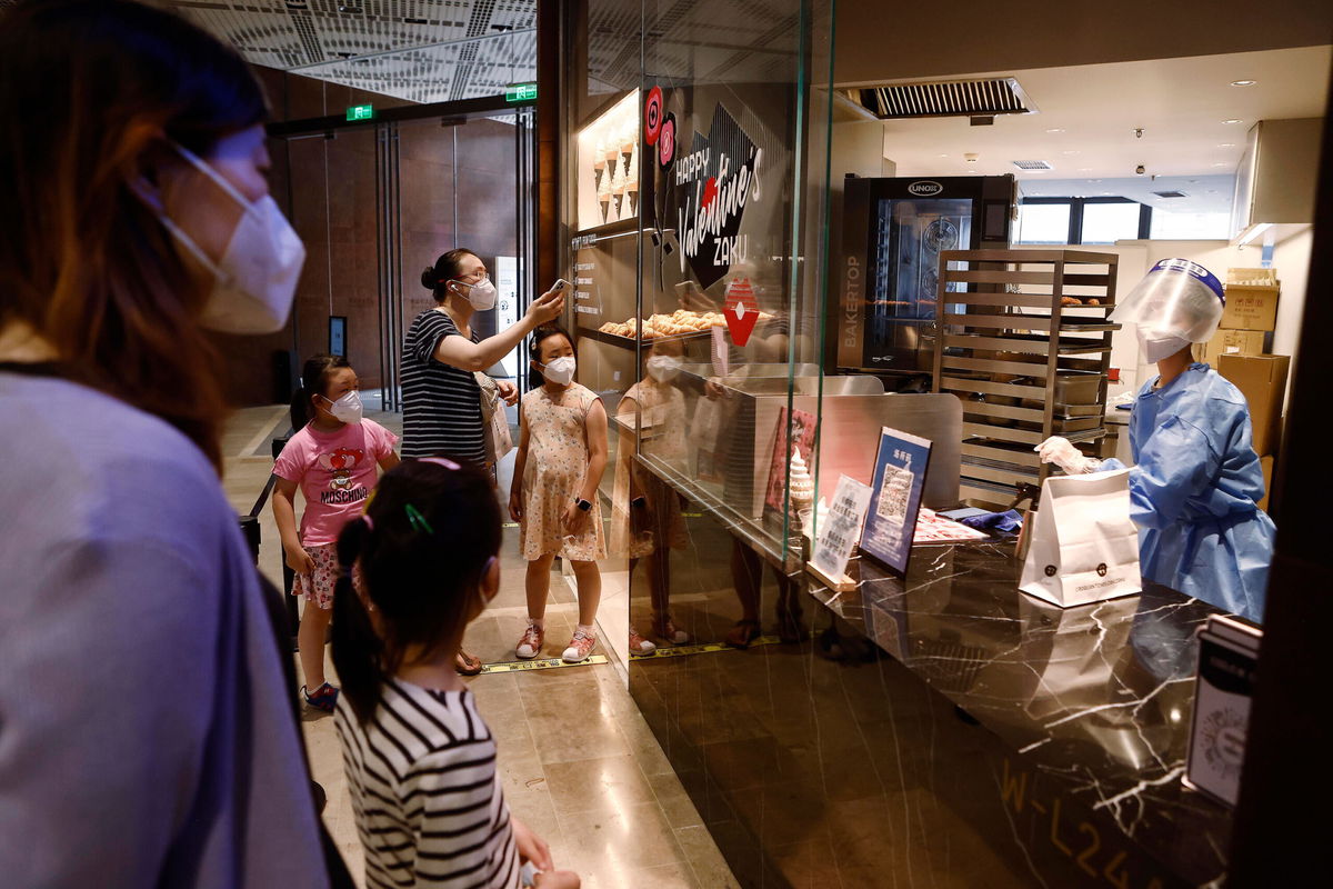 <i>Yin Liqin/China News Service/Getty Images</i><br/>Customers shop for bread at 