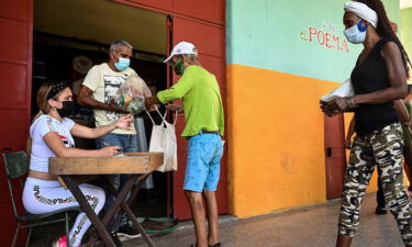 Cubans collect donated food at a supermarket in Havana in August 2021.