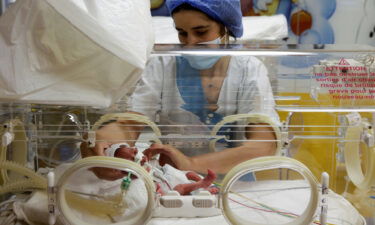 A nurse takes care of one of the newborn nonuplets