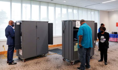 Sen. Raphael Warnock casts his ballot in the state's general primary at a Fulton County polling station in Atlanta