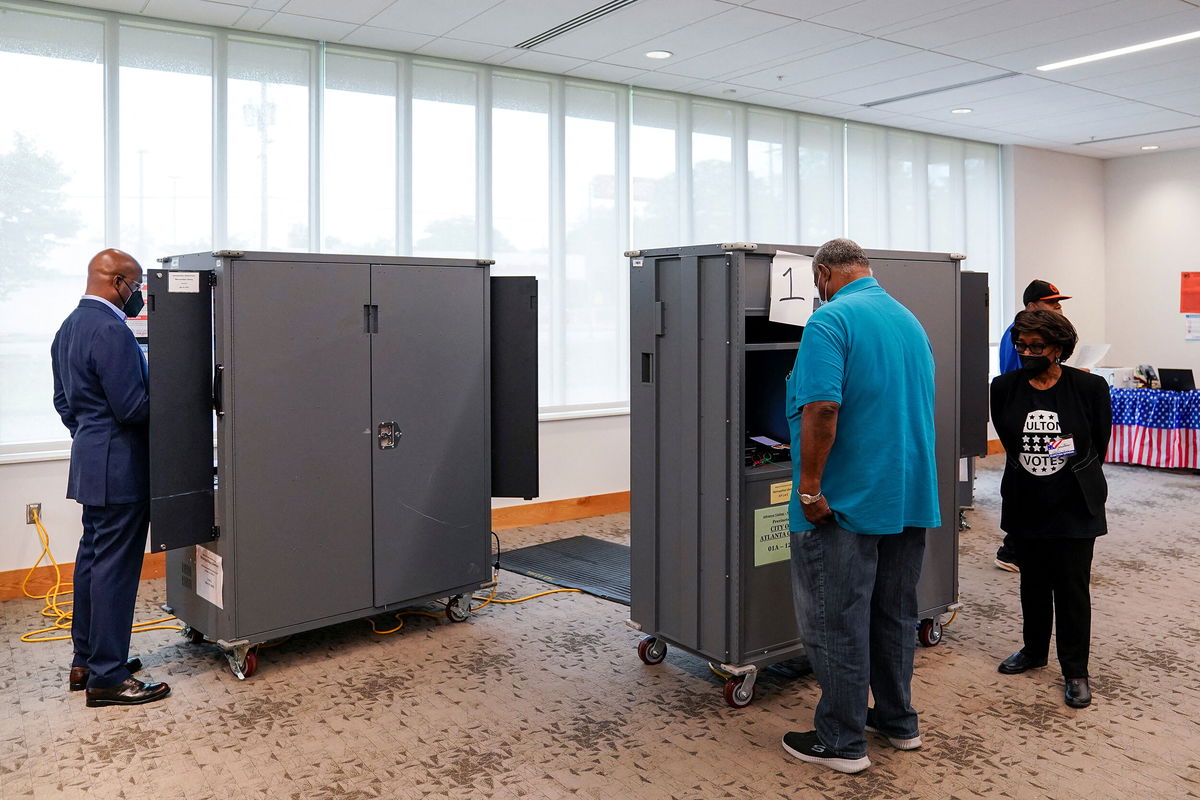 <i>Elijah Nouvelage/Reuters</i><br/>Sen. Raphael Warnock casts his ballot in the state's general primary at a Fulton County polling station in Atlanta