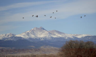 A climber was missing and two others were injured after a rockfall and avalanche on Mount Meeker in Colorado's Rocky Mountain National Park on Sunday morning. Pictured are Longs Peak and Mount Meeker in this 2016 file photo.