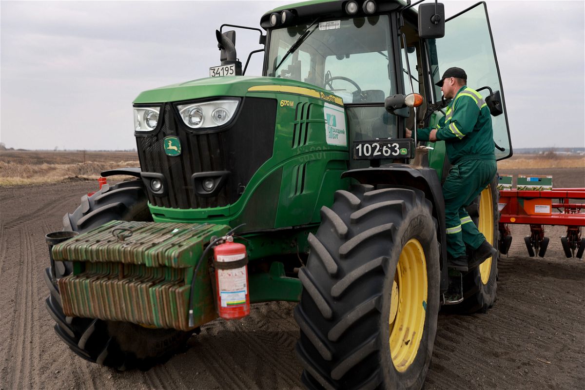 <i>Joe Raedle/Getty Images</i><br/>Ukrainian farmer Morda Vasyl steps into the cab of a John Deere tractor.