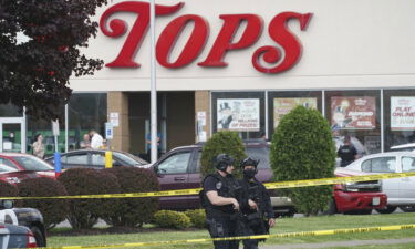 Police secure an area around a supermarket where several people were killed in a shooting