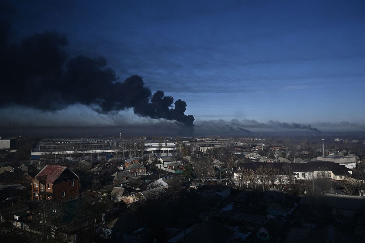 <i>Aris Messinis/AFP/Getty Images</i><br/>Black smoke rises from a military airport in Chuguyev near Kharkiv on February 24.