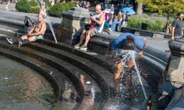 People try to cool off from the sweltering heat last August in New York City's Washington Square Park.