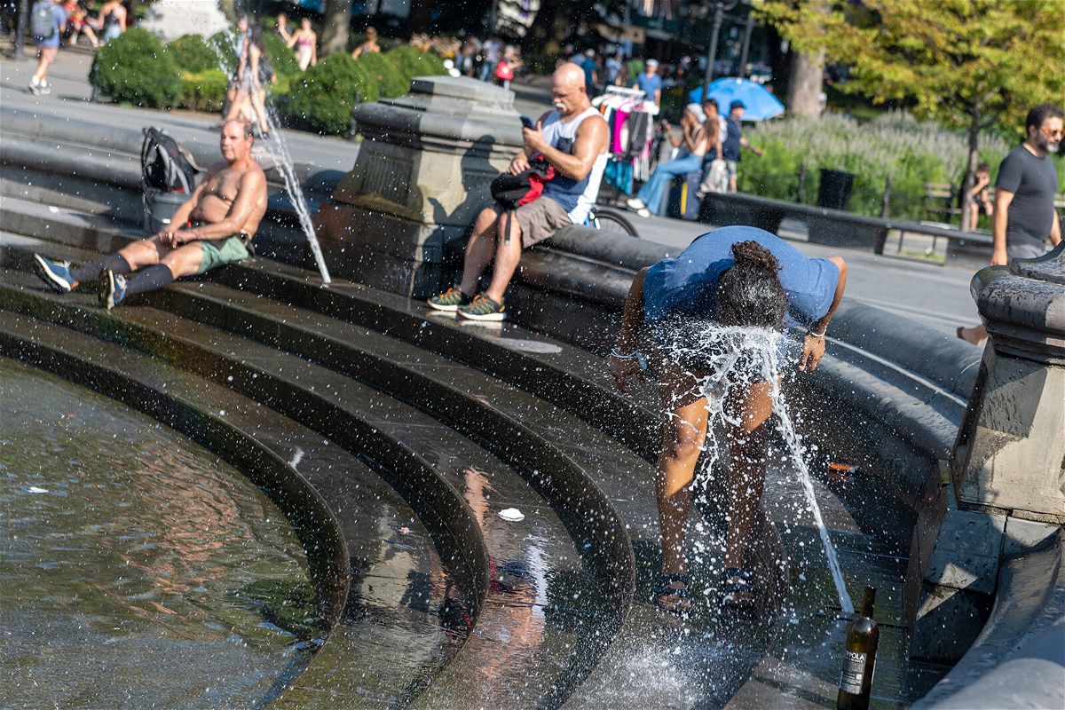 <i>Alexi Rosenfeld/Getty Images</i><br/>People try to cool off from the sweltering heat last August in New York City's Washington Square Park.
