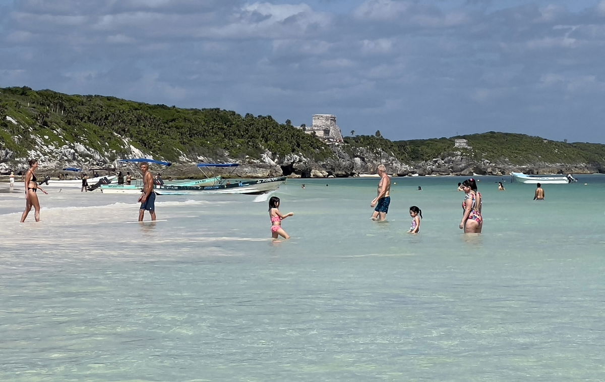 <i>Daniel Slim/AFP via Getty Images</i><br/>People spend time at Tulum beach