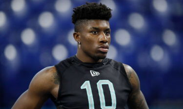 Jeff Gladney watches the 40-yard dash at the NFL football scouting combine in Indianapolis on March 1