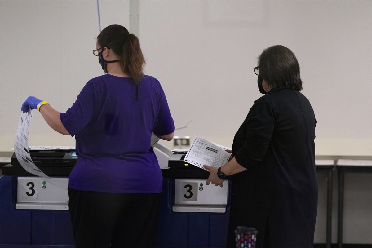 <i>Ross D. Franklin/AP</i><br/>Despite warnings that ditching voting machines would delay election results