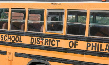 A student wearing a face mask rides a school bus on May 23 in Philadelphia. Philadelphia-area schools reinstated face masks in schools