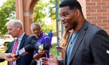 US Senate candidate Herschel Walker speaks with the media after a campaign rally at the Georgia Sports Hall of Fame in Macon