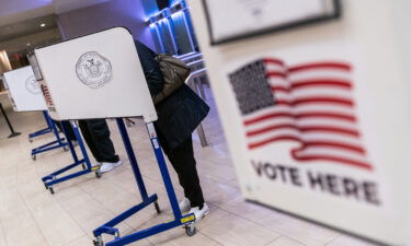 Voters cast ballots at an early voting location in Madison Square Garden in New York City on October 26