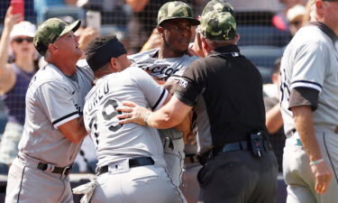 Tim Anderson is restrained by teammate José Abreu during Saturday's game in New York.