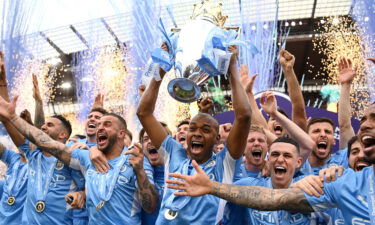 Manchester City lifts the trophy after a memorable title race against Liverpool.