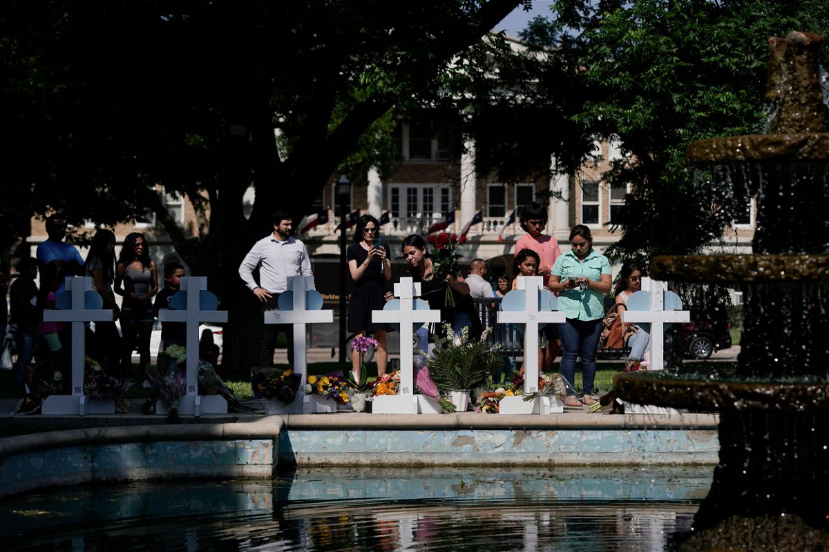 <i>Jae C. Hong/AP</i><br/>People pay their respects at a memorial site for the victims killed in this week's elementary school shooting in Uvalde