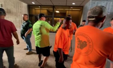 Members of the Pig Hunters Association of Oahu greet each other outside the DLNR.