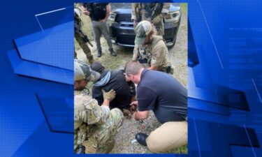 Erin Police Chief Mark Moore places handcuffs on BJ Brown.