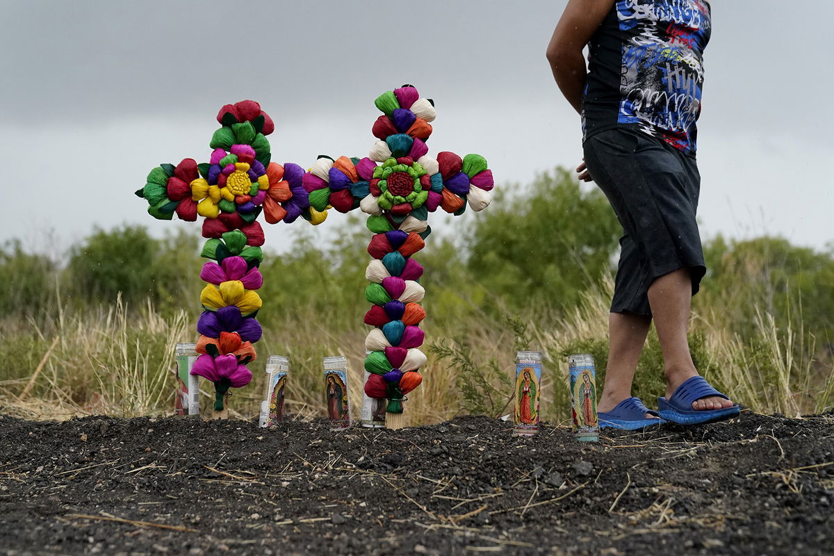 <i>Eric Gay/AP</i><br/>A man pays his respects at a makeshift memorial for the victims in San Antonio.