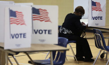 A voter casts her ballot at a polling station at Rose Hill Elementary School during the midterm primary election on June 21 in Alexandria