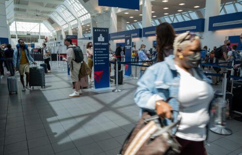 People travel through the terminal at John F. Kennedy Airport at the start of the Memorial Day weekend on May 27