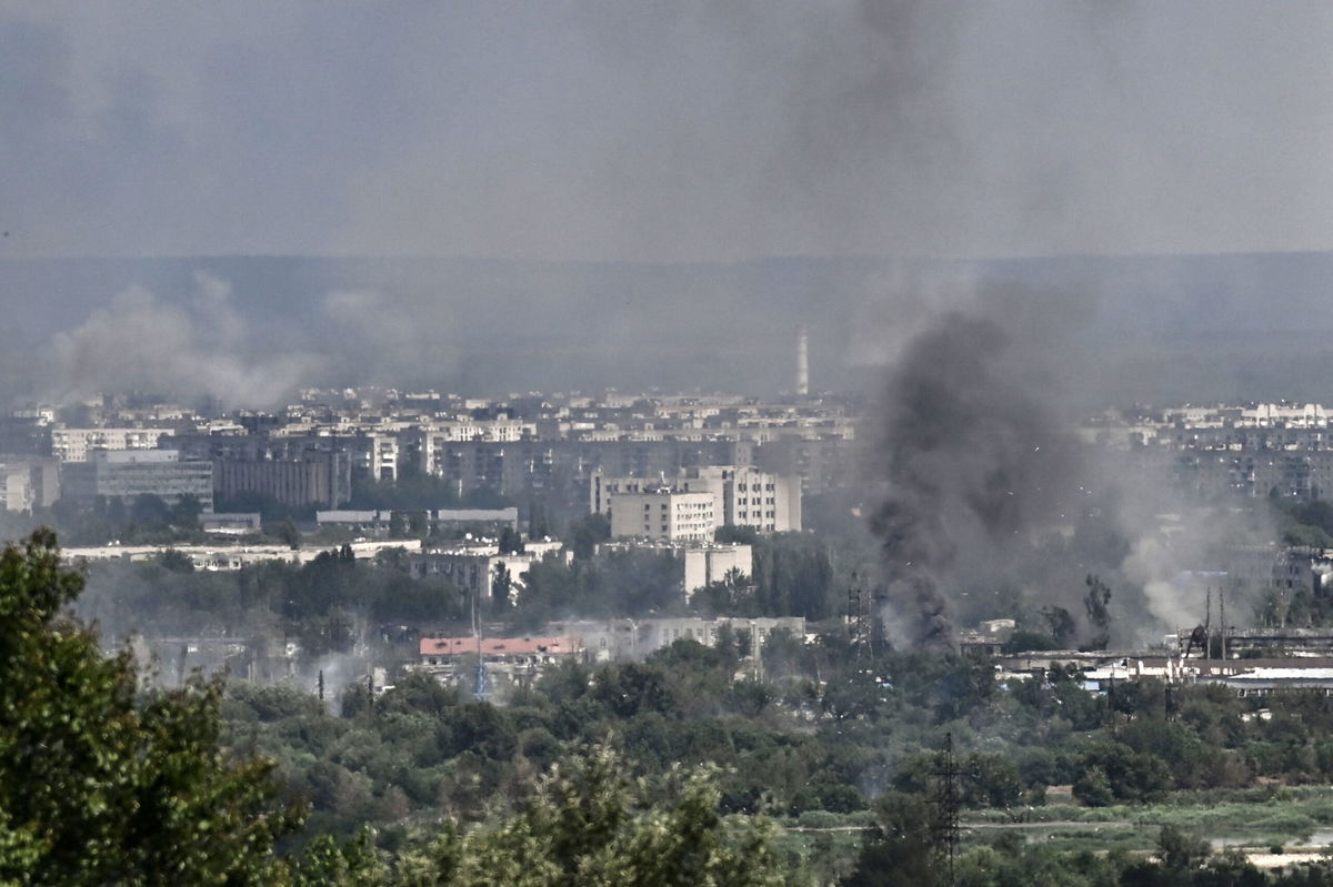 <i>Aris Messinis/AFP/Getty Images</i><br/>Smoke and dirt rise from the city of Severodonetsk on June 17.