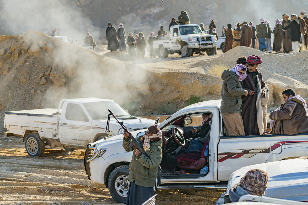 <i>Celestino Arce/NurPhoto/Getty Images</i><br/>A man celebrates the end of the Wadi Zalaga annual camel race by shooting with a rifle in Sinai